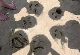 Faces In Sand